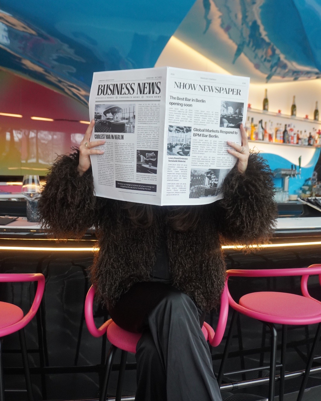 Guest reading a BPM Bar newspaper at the bar